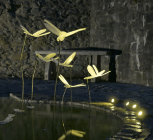 Plastic illuminated fireflies suspended above a pond